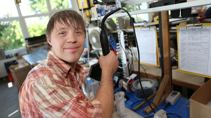 Ein Mitarbeitender an einem Arbeitsplatz in den Erfurter Werkstätten